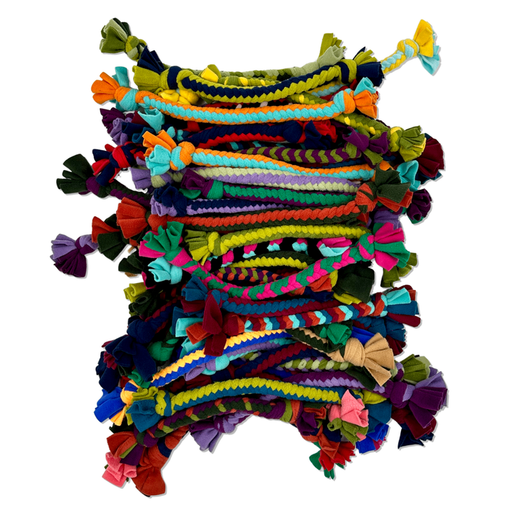 A large pile of multicolored Buddy Braids on a white background