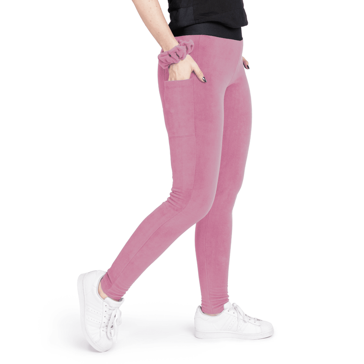 A woman wears rose pink leggings in front of a white background