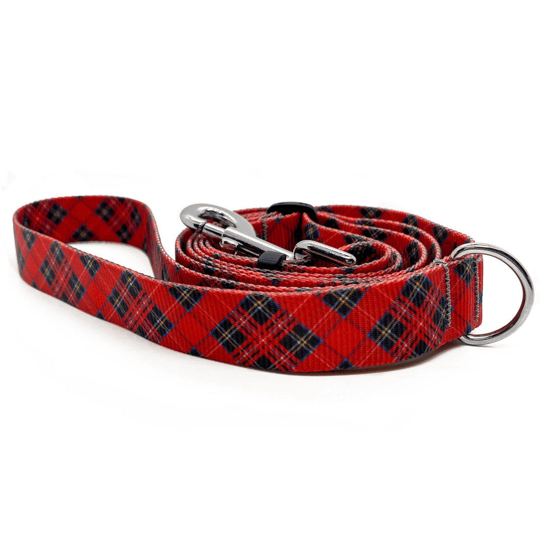 A red plaid adjustable leash in front of a white background