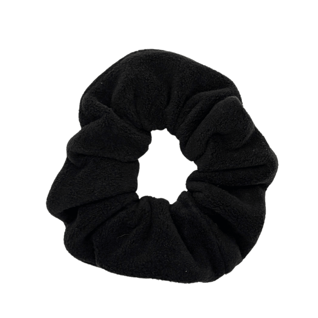 A black scrunchie in front of a white background