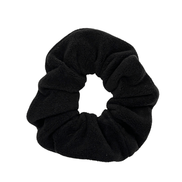 A black scrunchie in front of a white background