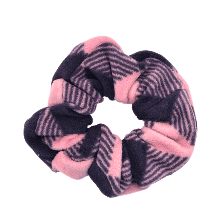 A rose pink and huckleberry purple buffalo check scrunchie in front of a white background