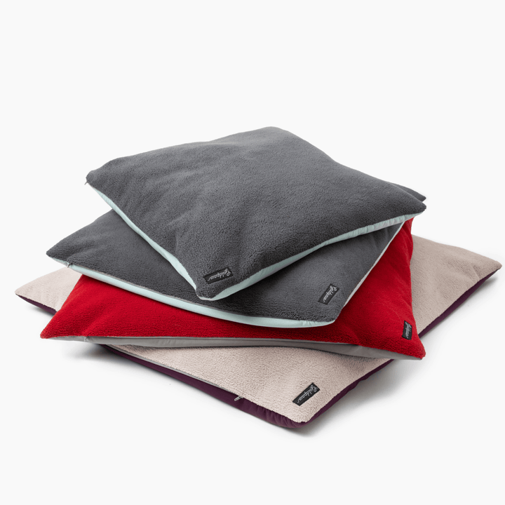 A stack of multicolored dog beds